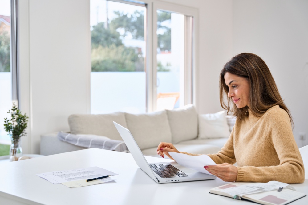 Middle-aged woman looking at laptop