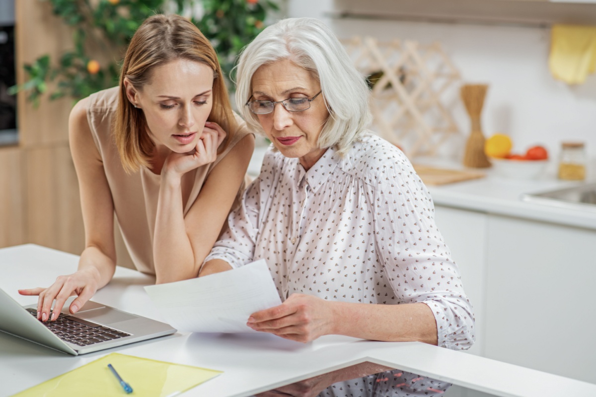 Middle-aged woman looking at paperwork with her mother