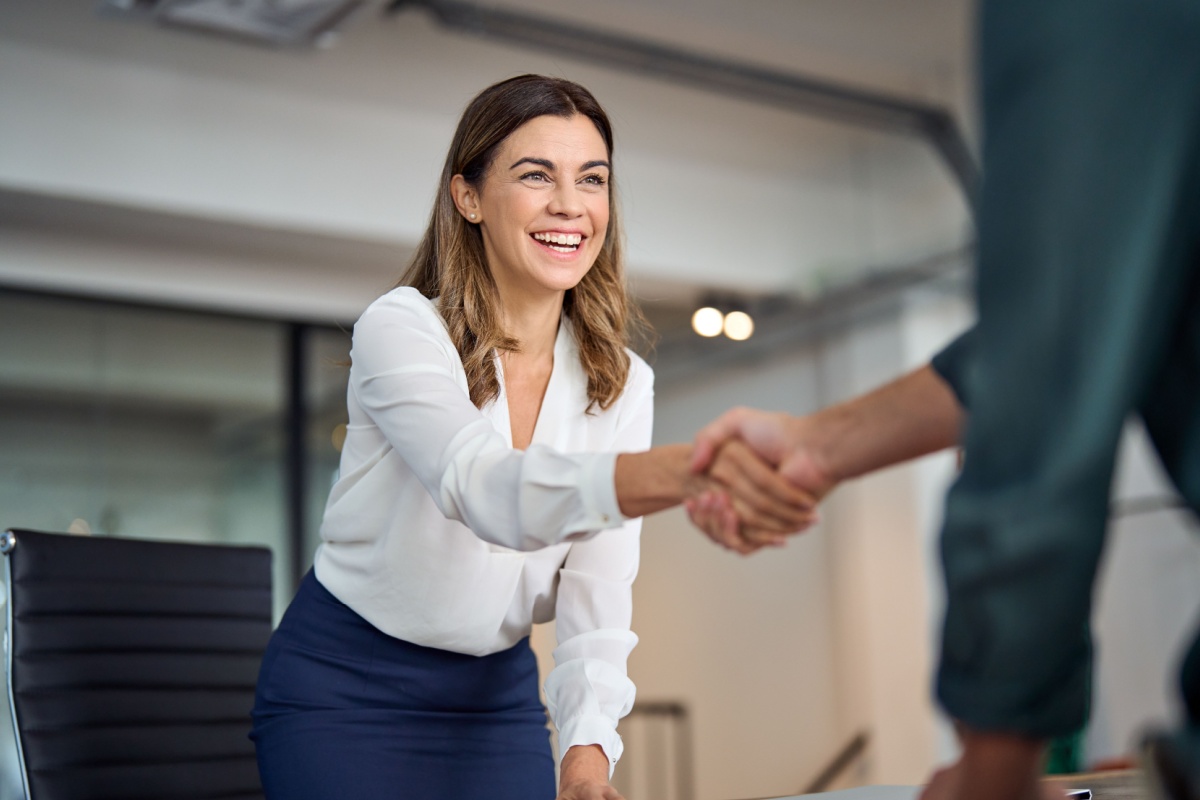 Female financial expert shaking hands with a business person