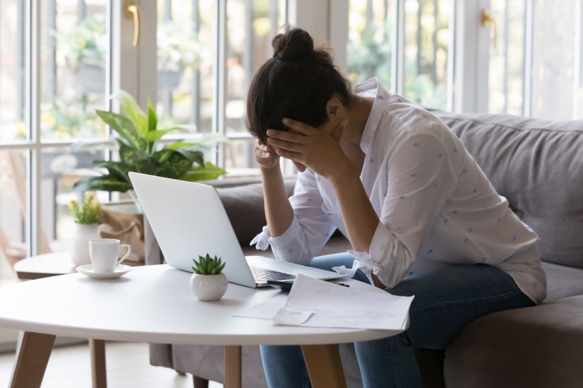 Stressed woman looking at a laptop
