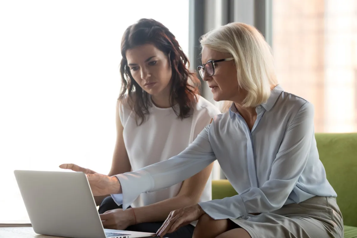 Female financial advisor and a female client looking at a laptop