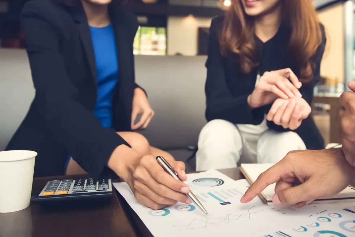 Financial expert and client looking at data charts