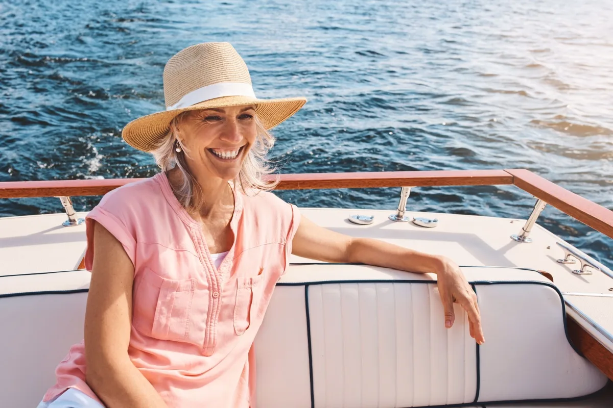happy retired woman sitting on a boat