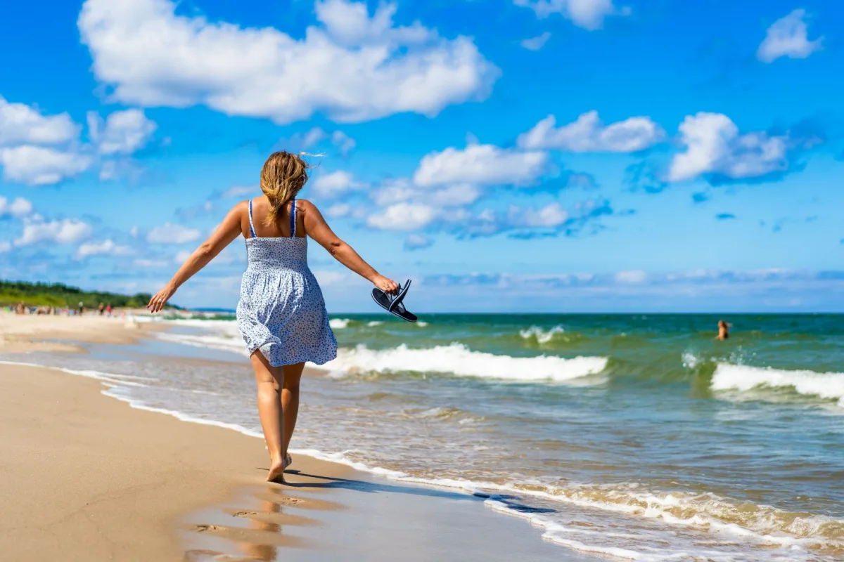 Middle-aged woman walking on a beach