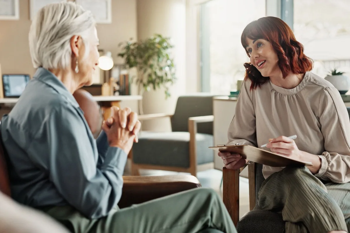 Mature woman talking to a younger female financial expert