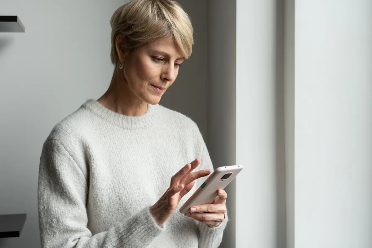 Middle-aged woman looking at her mobile phone