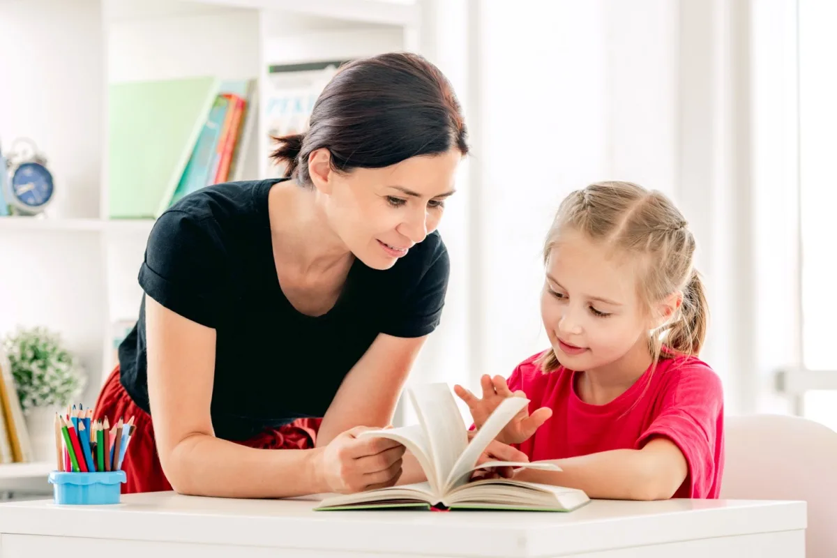 Middle-aged woman reading a book with a child