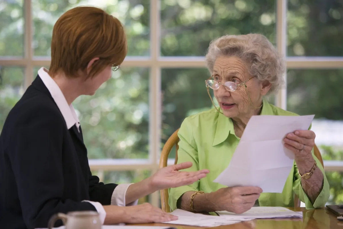 Senior woman talking to a female financial planner