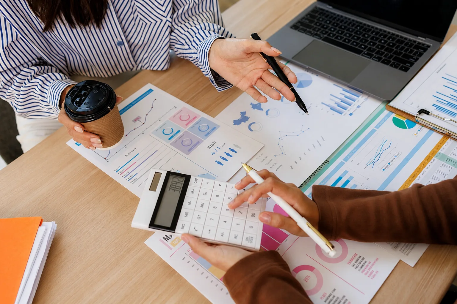 Women looking at finances and paperwork together