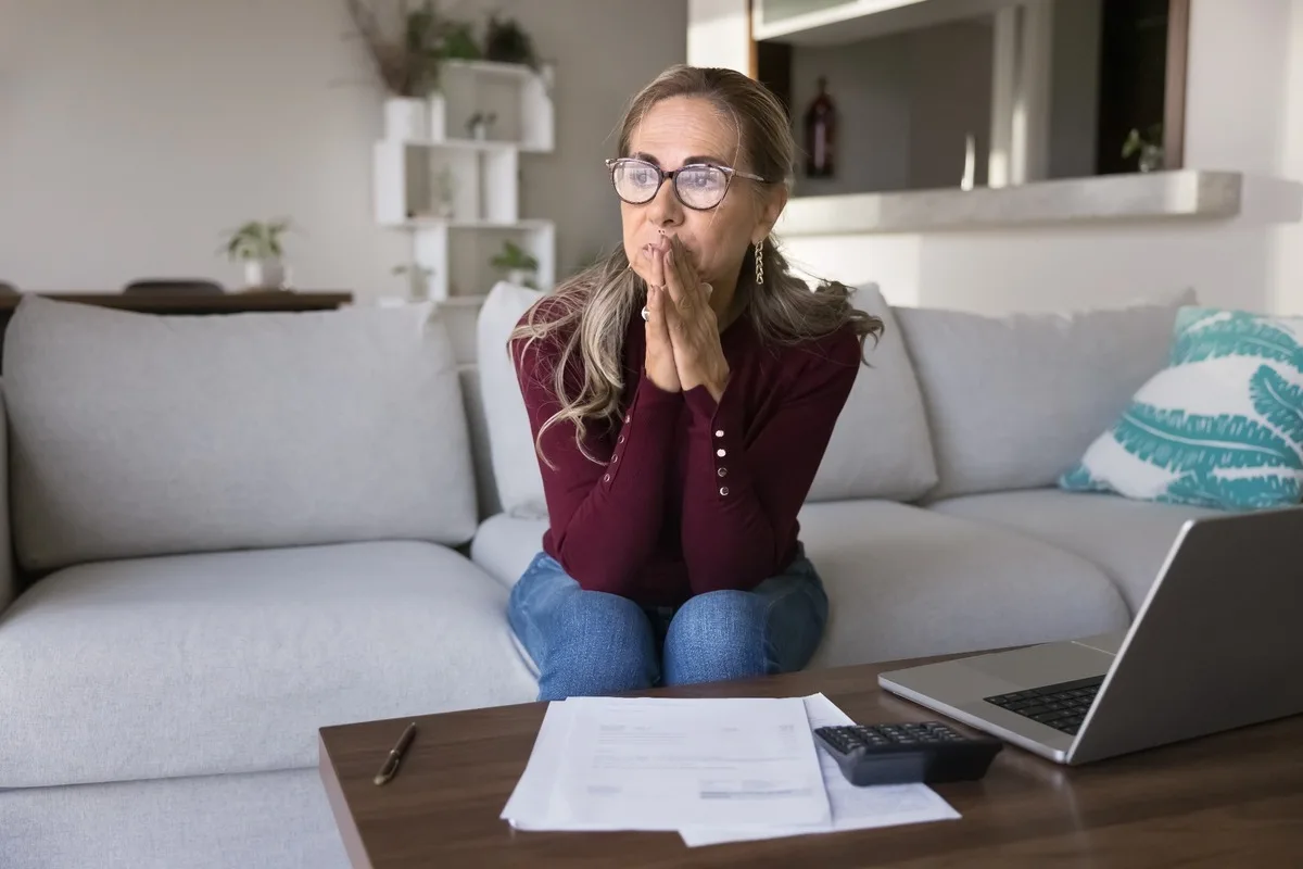 A stressed woman reviewing paperwork